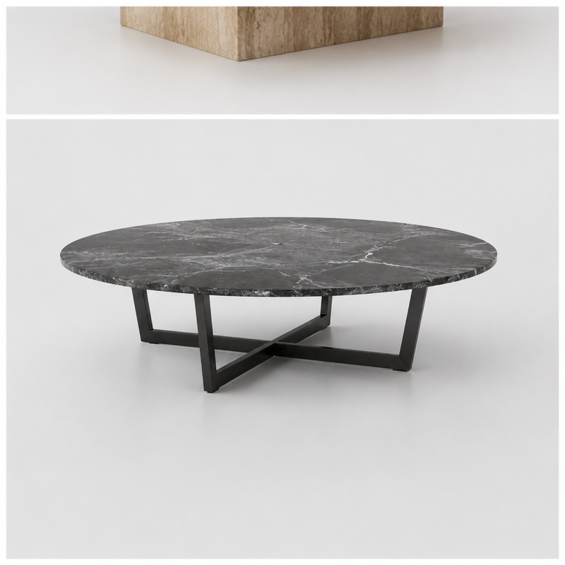 Round black marble coffee table with grey and white veining on black metal X-base