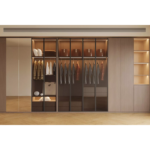 Luxury glass sliding door wardrobe in warm oak with matt black aluminium frame and LED lighting in Dubai villa bedroom