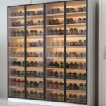 White tall shoe cabinet with LED lighting and glass doors in Dubai apartment entryway