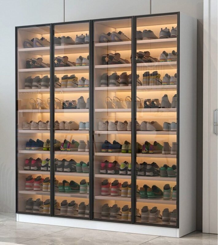 White tall shoe cabinet with LED lighting and glass doors in Dubai apartment entryway