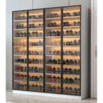 White tall shoe cabinet with LED lighting and glass doors in Dubai apartment entryway